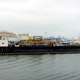 An oil lighter loads up, surrounded by a protective boom.